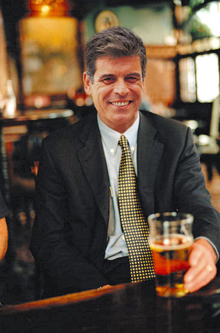 Meyers enjoys a beer at an airport bar in Atlanta.